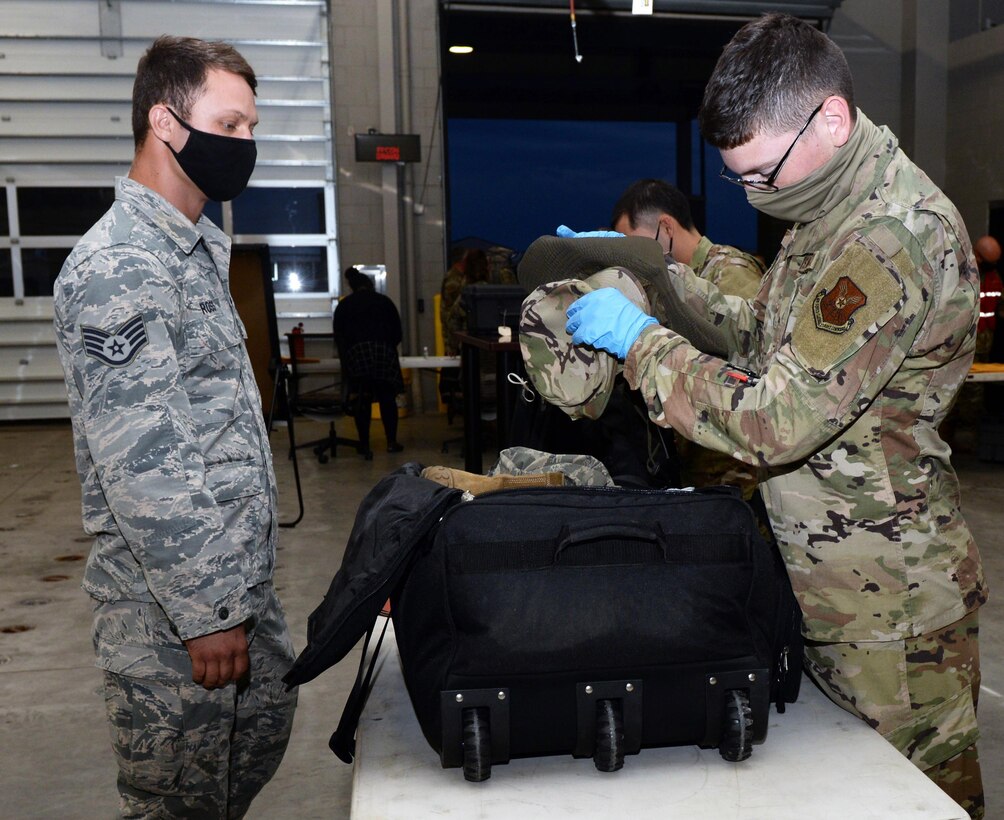 An Airman assigned to the 28th Logistics Readiness Squadron, Ellsworth Air Force Base, S.D., checks luggage as part of a mobility processing line in preparation for a Bomber Task Force deployment, July 13, 2020. Airmen from the 28th Bomb Wing deployed to the U.S. Indo-Pacific Command’s area of responsibility to conduct Bomber Task Force missions, which help maintain global stability and security while enabling units to become familiar in different regions. (U.S. Air Force photo by Airman 1st Class Quentin K. Marx)