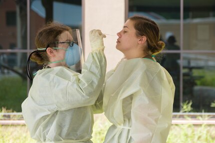 Hospital Corpsmen from Naval Health Clinic Charleston perform a practice COVID-19 swab test on July 8, 2020 at the NHCC on Joint Base Charleston, S.C. The Hospital Corpsmen were tasked with learning how to administer a COVID-19 swab test. The training will be used to test symptomatic patients and Sailors as well as asymptomatic Sailors to attempt to lessen the spread of the virus.