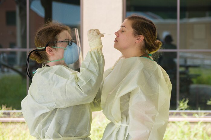 Hospital Corpsmen from Naval Health Clinic Charleston perform a practice COVID-19 swab test on July 8, 2020 at the NHCC on Joint Base Charleston, S.C. The Hospital Corpsmen were tasked with learning how to administer a COVID-19 swab test. The training will be used to test symptomatic patients and Sailors as well as asymptomatic Sailors to attempt to lessen the spread of the virus.
