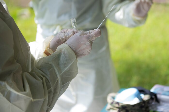 Hospital Corpsmen from Naval Health Clinic Charleston perform a practice COVID-19 swab test on July 8, 2020 at the NHCC on Joint Base Charleston, S.C. The Hospital Corpsmen were tasked with learning how to administer a COVID-19 swab test. The training will be used to test symptomatic patients and Seamen as well as asymptomatic Seamen to attempt to lessen the spread of the virus.