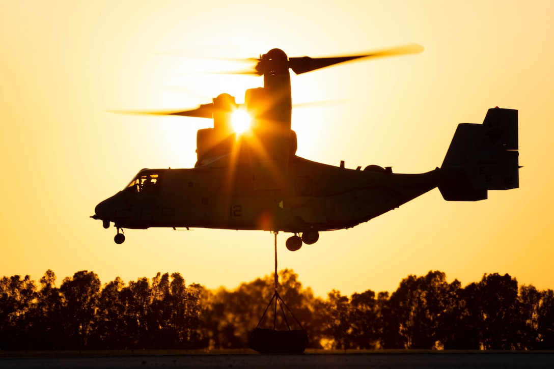 An MV-22B Osprey hoists a cargo net of tires during an external-lift exercise aboard at Morόn Air Base, Spain, July 9.