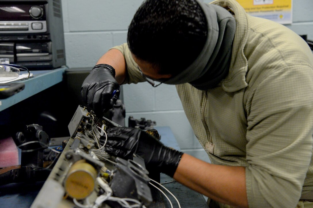 A photo of Senior Airman Desmond A. Charles repairing an MAU-12 Ejector Rack Assembly.