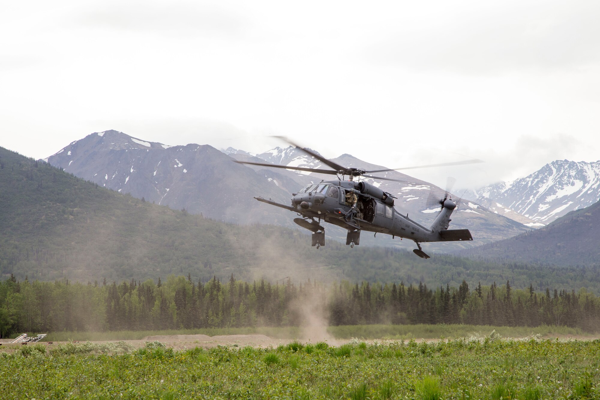 An Alaska Air National Guard 210th Rescue Squadron HH-60 Pave Hawk helicopter hovers during fast-trope training at Bryant Army Airfield on Joint Base Elmendorf-Richardson May 29, 2014. The 210th Rescue Squadron provides emergency rescue services for the citizens of Alaska in addition to training for wartime combat search and rescue missions. (U.S. Army National Guard photo by Sgt. Balinda O’Neal)