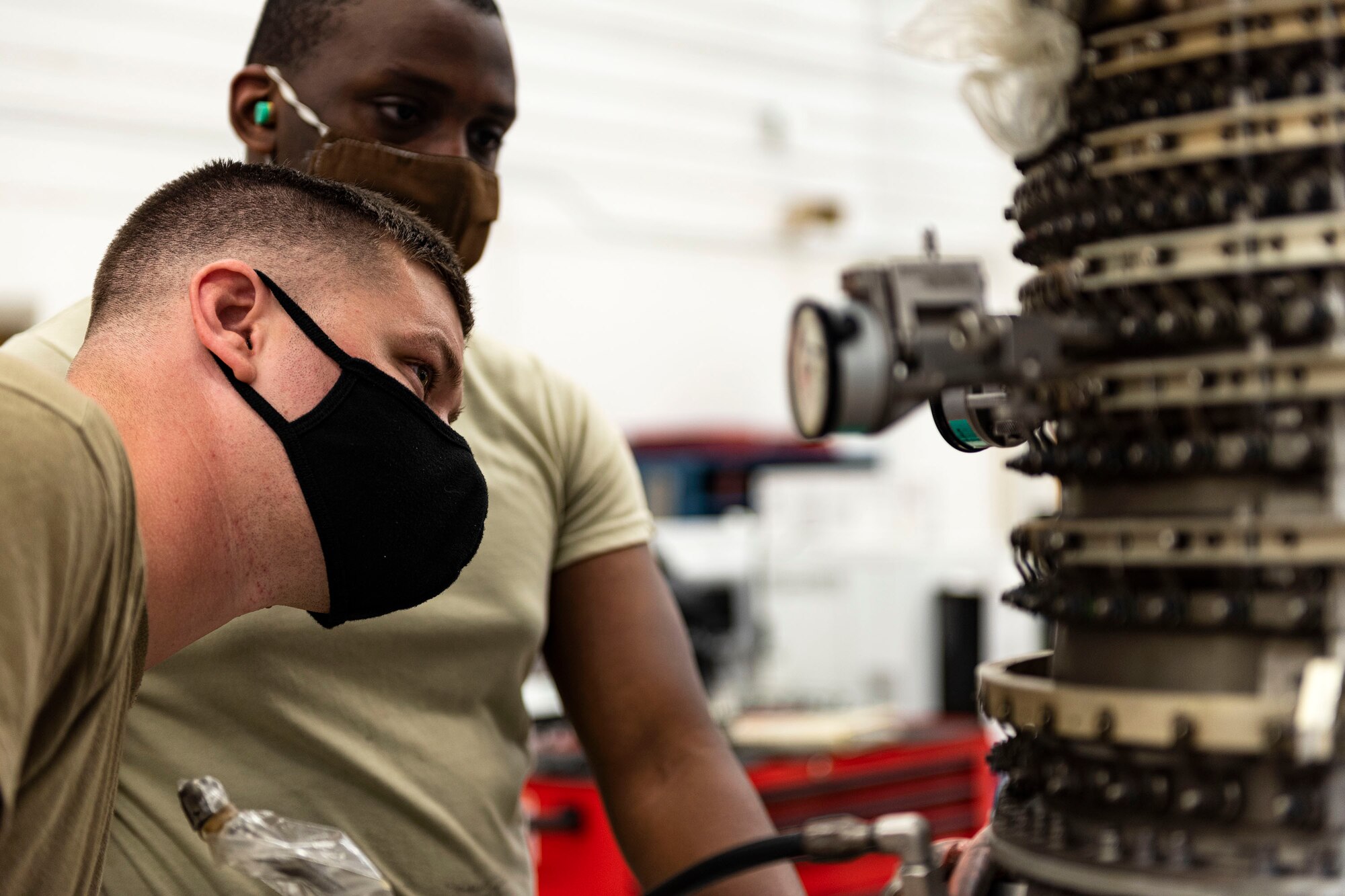 Photo of Airmen working on a TF34 engine.