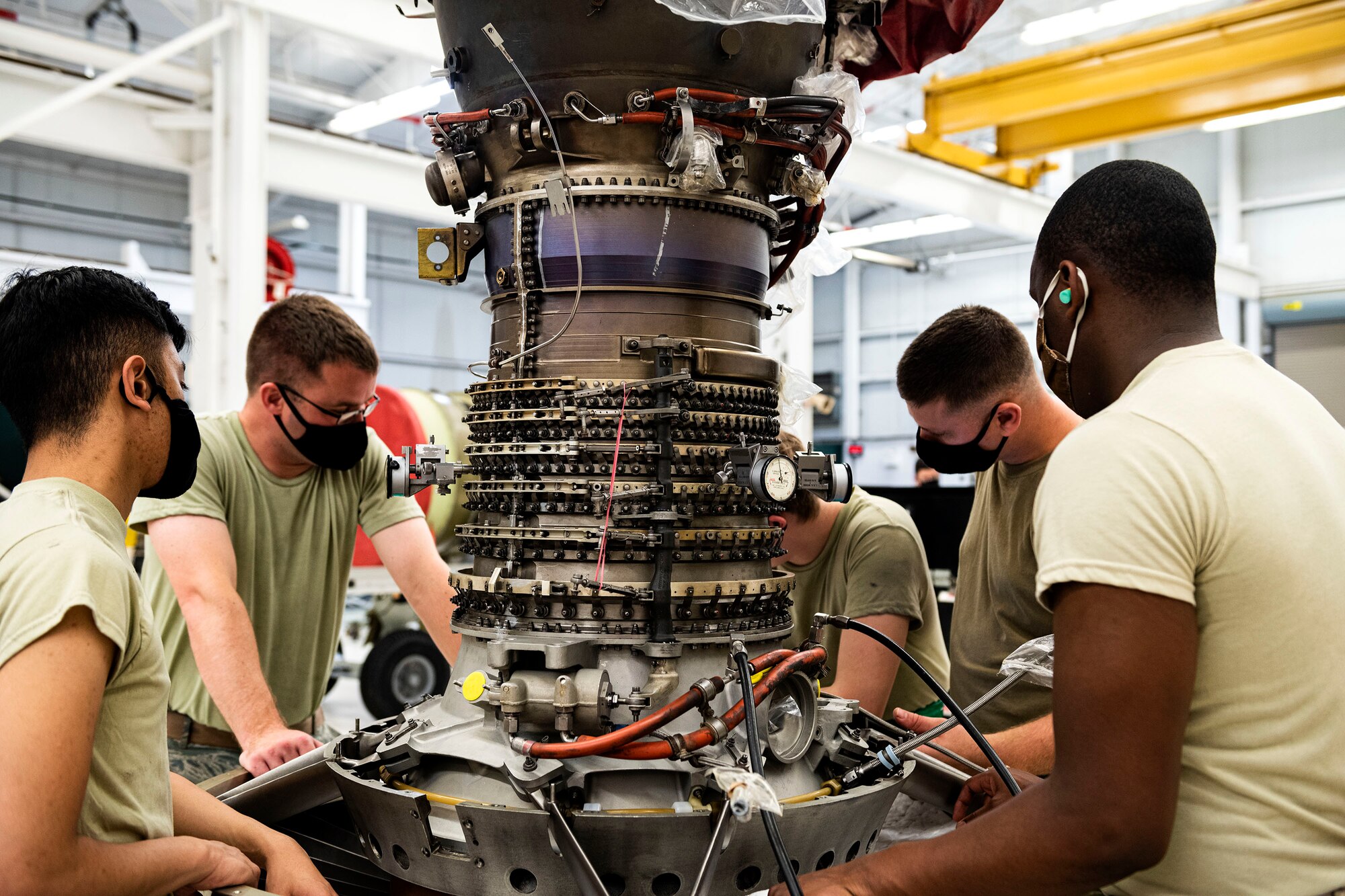 Photo of Airmen working on a TF34 engine.