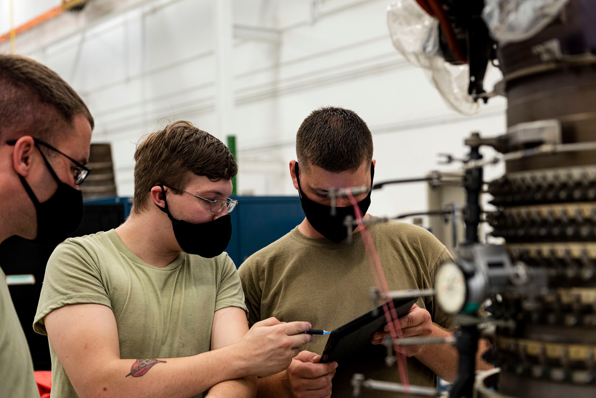 Photo of Airmen working on a TF34 engine.