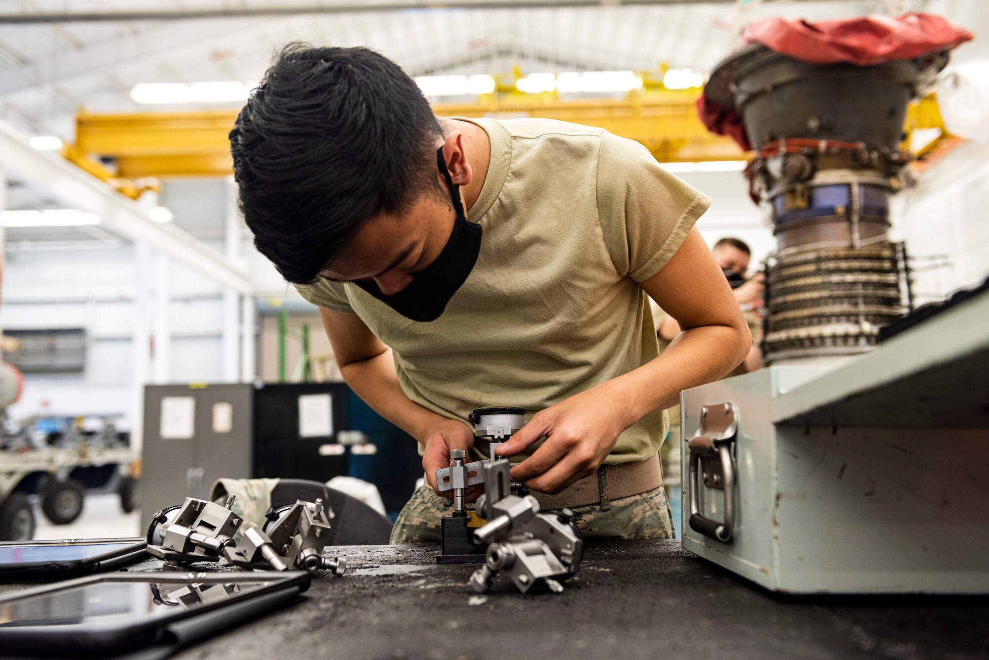 Photo of Airmen working on a TF34 engine.