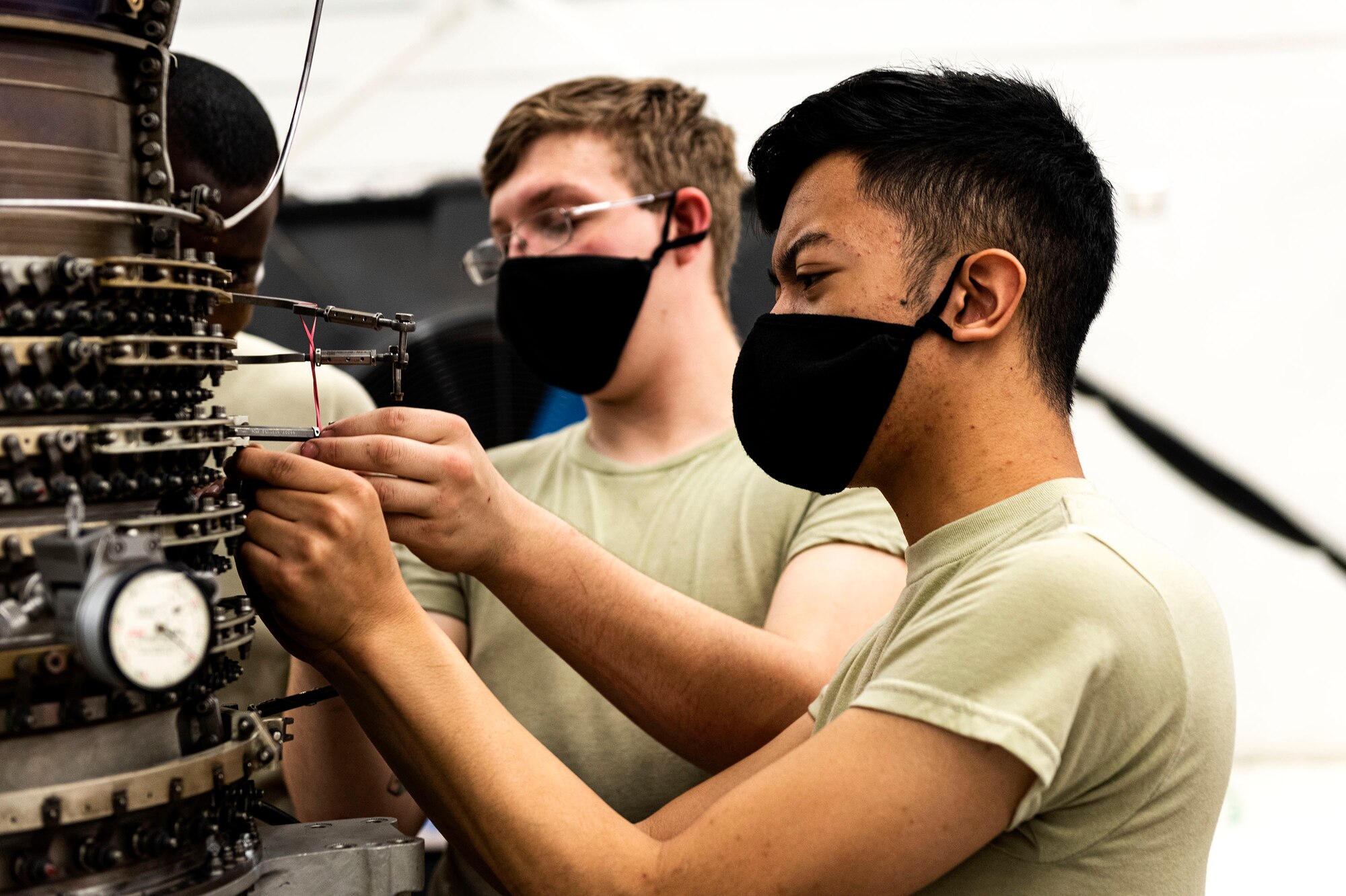 Photo of Airmen working on a TF34 engine.
