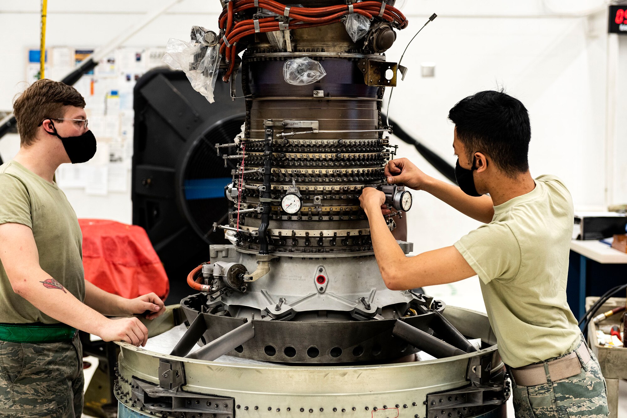 Photo of Airmen working on a TF34 engine.