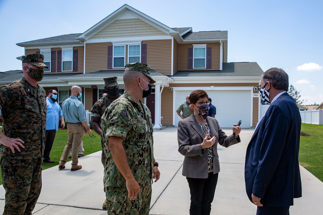 Nina McBroom, center, regional program housing manager, Marine Corps Installations East-Marine Corps Base Camp Lejeune briefs Charles A. Williams, Jr., right, assistant secretary of the Navy for Energy, Installations and Environment, on military housing in the Heroes Manor community during a tour on MCB Camp Lejeune, July 14, 2020. Williams visited MCB Camp Lejeune and Marine Corps Air Station New River to receive an update on military construction from installation leaders and view hurricane related repairs to facilities and family housing currently in progress. (U.S. Marine Corps photo by Lance Cpl. Christian Ayers)