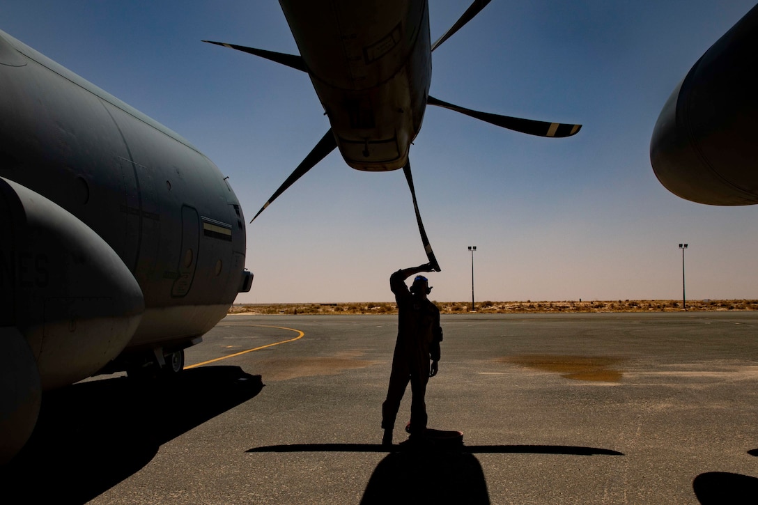A U.S. Marine conducts a preflight inspection during a division flight in Kuwait, June 24.
