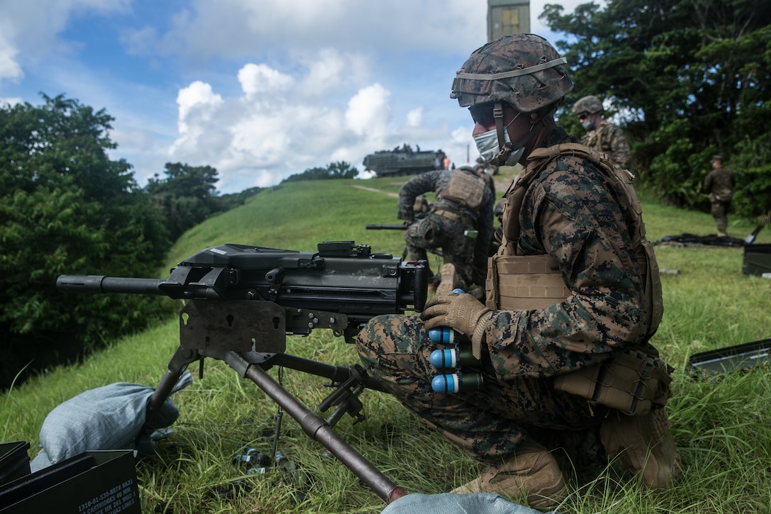 A U.S. Marine prepares to load 40mm practice M781 rounds into an Mk-19 at Camp Schwab, Okinawa, Japan, June 29.