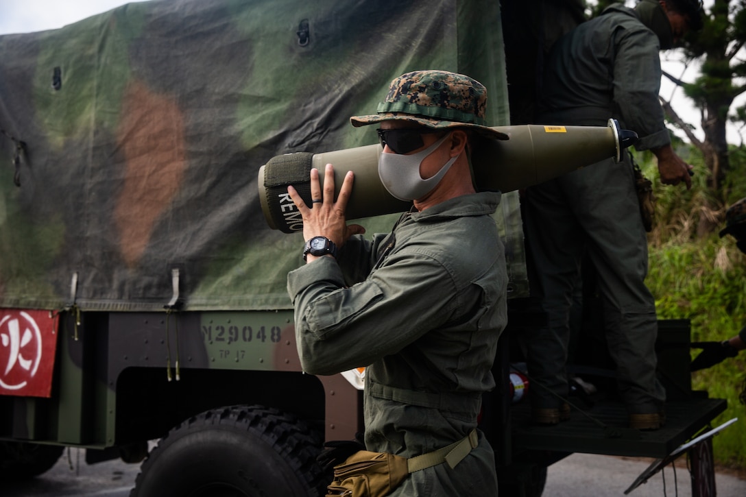 A U.S. Marine unloads a 155mm round during an ordinance detonation range on Okinawa, Japan, July 13.