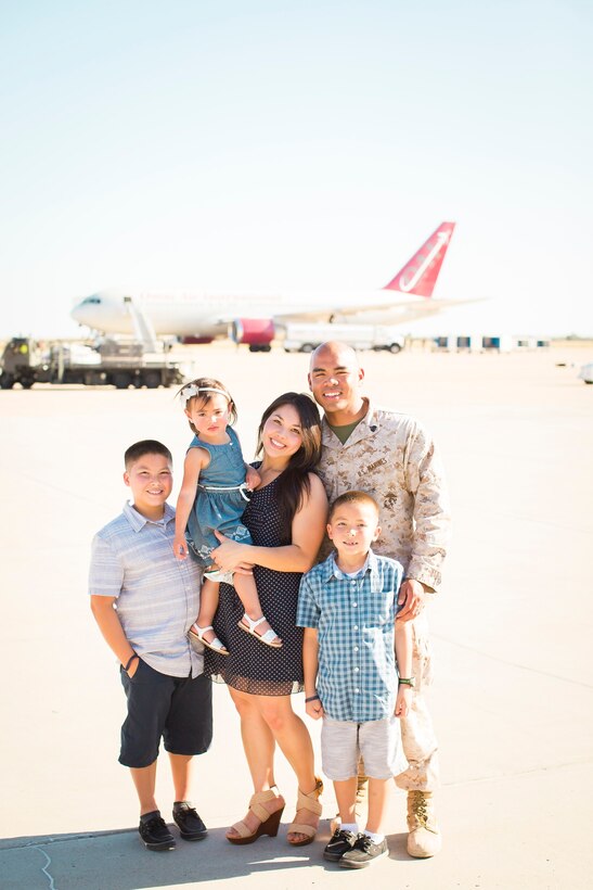 Staff Sgt. Fructuoso Santos poses with his childhood friend and wife, Tiana, and their three children at Marine Corps Air Station Miramar, California. The Santos family resides in Statesboro, Georgia, where Santos serves as a canvasing recruiter with Recruiting Station Columbia.