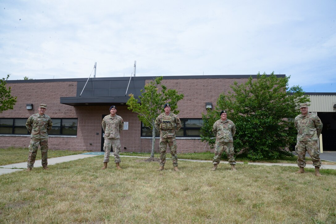 A photo of Chief Master Sgt. Michael J. Rakauckas and Chief Master Sgt. James F. McCloskey, posing for a photo with three 177th Security Forces Squadron members.