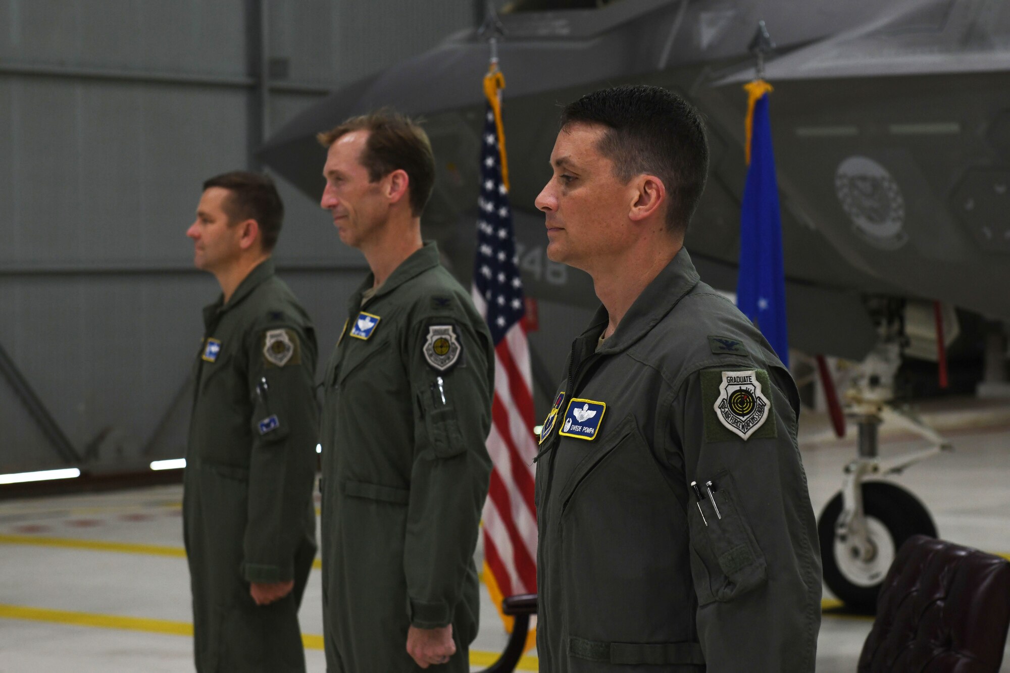 Air Force Col. Jon Wheeler, left, 33rd Fighter Wing commander, Col. Brian O’Neill, middle, outgoing 33rd Operations Group commander, and Col. Byron Pompa, incoming 33rd OG commander, right, stand at attention, during the 33rd OG change of command at Eglin Air Force Base, Florida, July 17, 2020. The change of command is the military’s formal transfer of command responsibility from one commander to the next. (U.S. Air Force photo by Airman 1st Class Heather Leveille)