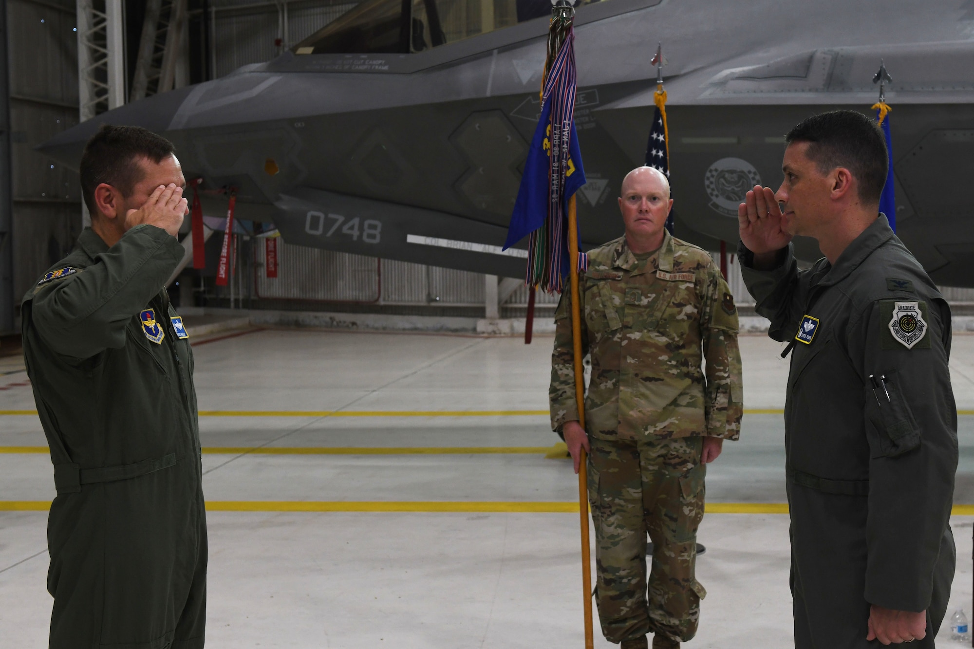 Air Force Col. Byron Pompa, incoming 33rd OG commander, salutes Col. Jon Wheeler, 33rd Fighter Wing commander, during the 33rd OG change of command at Eglin Air Force Base, Florida, July 17, 2020. Pompa rendered his first salute as the new 33rd OG commander. (U.S. Air Force photo by Airman 1st Class Heather Leveille)