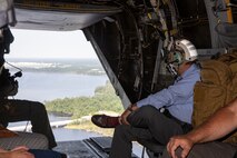 Charles A. Williams, Jr., assistant secretary of the Navy for Energy, Installations and Environment, looks out the back of a MV-22 Osprey during a tour of Marine Corps Base Camp Lejeune and Marine Corps Air Station New River, July 15, 2020. Williams visited MCB Camp Lejeune and MCAS New River to receive an update on military construction from installation leaders and view hurricane related repairs to facilities and family housing currently in progress. (U.S. Marine Corps photo by LCpl. Christian Ayers)
