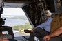 Charles A. Williams, Jr., assistant secretary of the Navy for Energy, Installations and Environment, looks out the back of a MV-22 Osprey during a tour of Marine Corps Base Camp Lejeune and Marine Corps Air Station New River, July 15, 2020. Williams visited MCB Camp Lejeune and MCAS New River to receive an update on military construction from installation leaders and view hurricane related repairs to facilities and family housing currently in progress. (U.S. Marine Corps photo by LCpl. Christian Ayers)