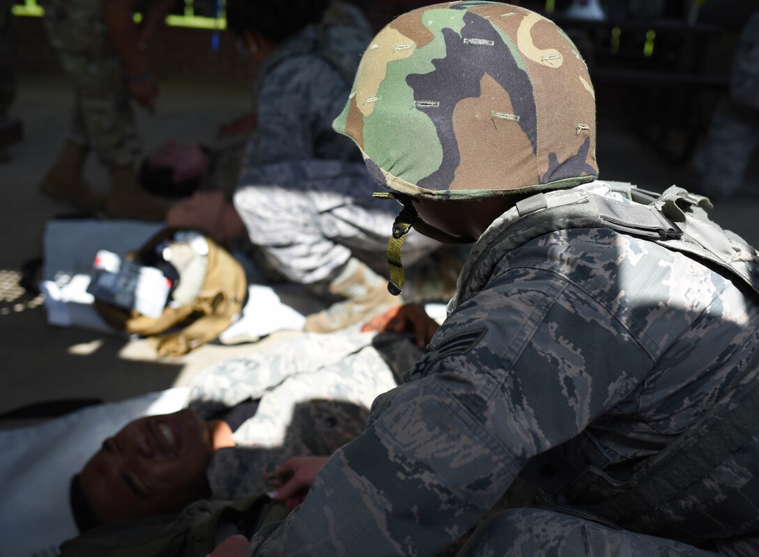 A 14th Medical Group Airman treats a ‘wounded’ actor in a simulated battlefield during the Tactical Combat Casualty Care All Combatants course July 16, 2020, at the Kortiz Clinic on Columbus Air Force base, Miss. The event challenged medics to perform battlefield care in a simulated combat environment to help bolster their medical skills by performing on actors and dummies. (U.S. Air Force photo by Senior Airman Jake Jacobsen)