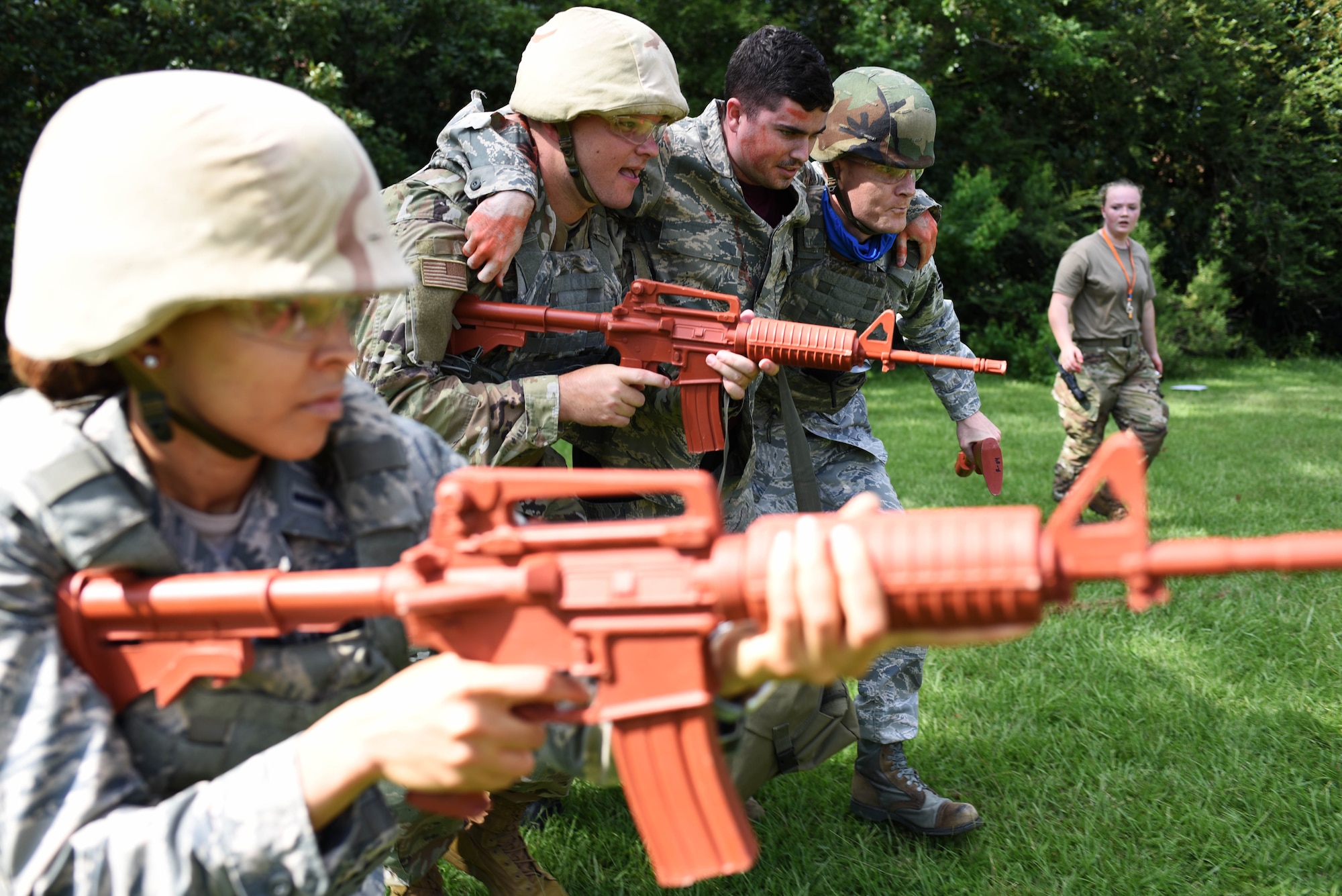 14th Medical Group Airmen carry a ‘wounded’ actor in a simulated battlefield during the Tactical Combat Casualty Care All Combatants course July 16, 2020, at the Kortiz Clinic on Columbus Air Force base, Miss. The TCCC training is a simulated immersion training on stabilizing trauma victims from common battlefield injuries such as hemorrhage, airway obstruction and shock. (U.S. Air Force photo by Senior Airman Jake Jacobsen)