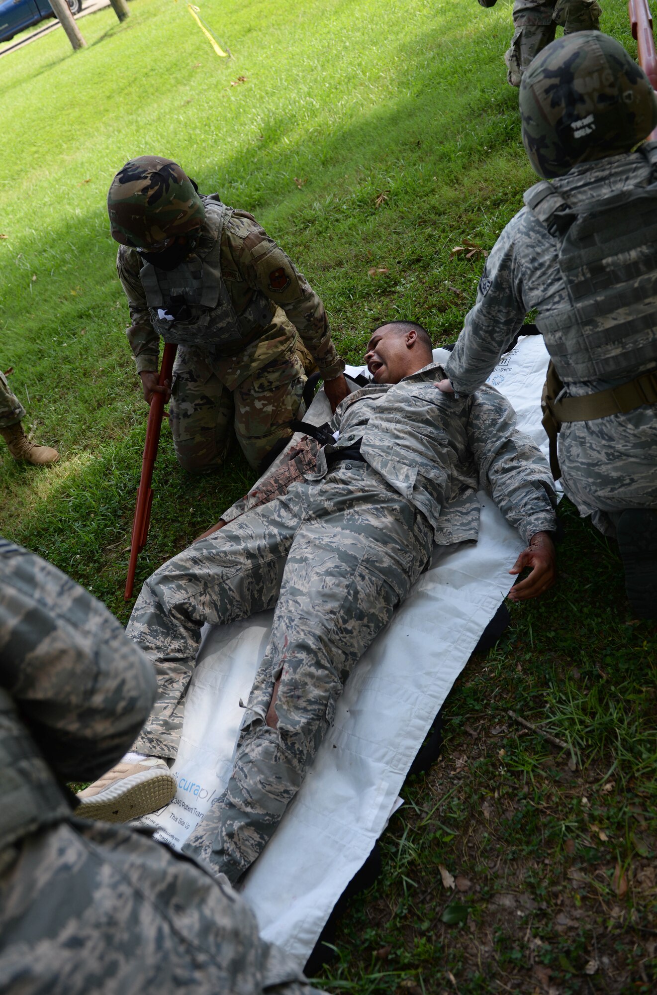 14th Medical Group Airmen practice treatment on an augmented mannequin during the Tactical Combat Casualty Care All Combatants course July 16, 2020, at the Kortiz Clinic on Columbus Air Force base, Miss. The TCCC teaches first-responders treatment of the most preventable causes of death on the battlefield, such as controlling a hemorrhage, treating penetrating chest wounds, airway protection and tourniquet application. (U.S. Air Force photo by Airman 1st Class Davis Donaldson)