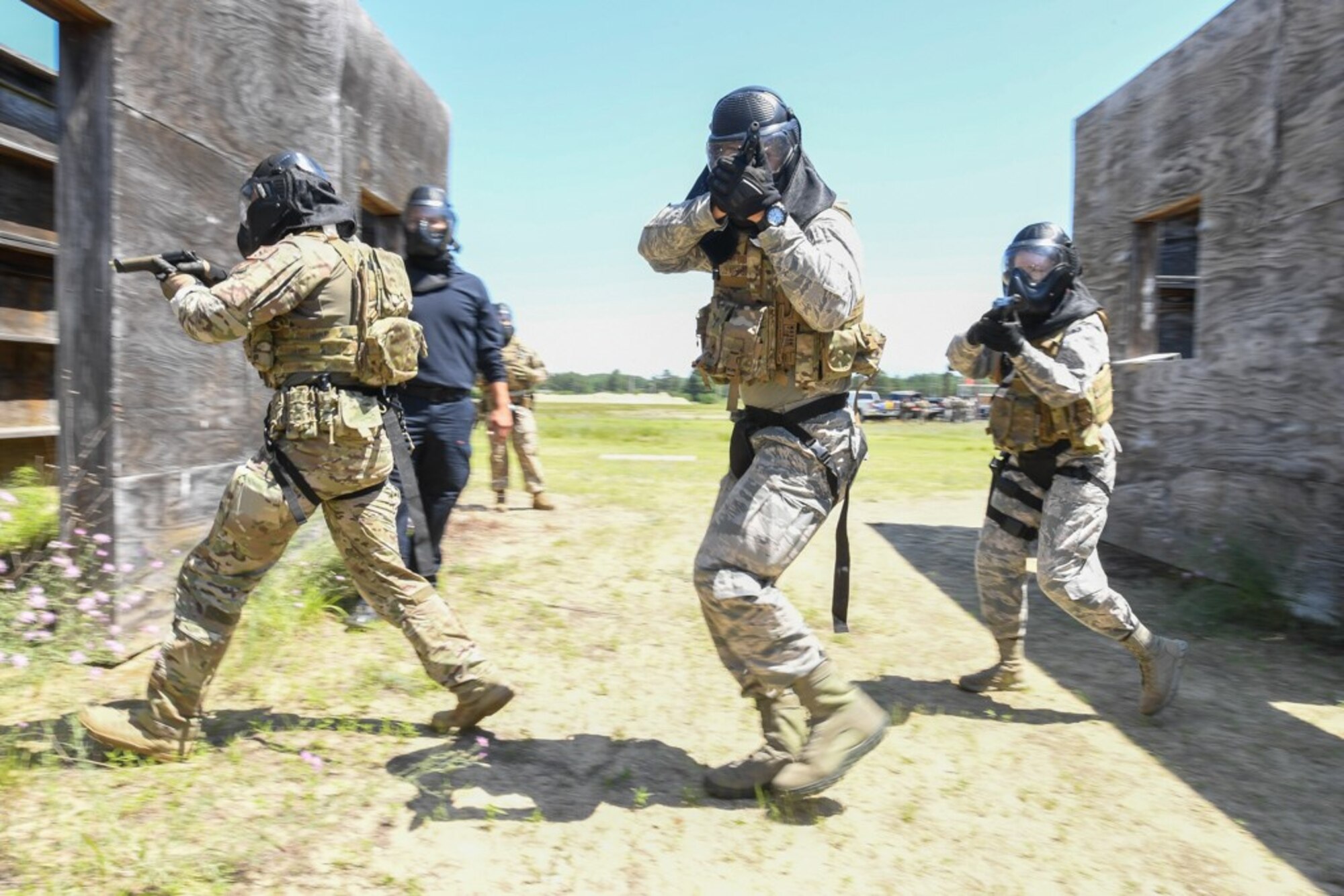 Senior Airman Ajay Cease, from left, Airman 1st Class Carlos Laboy Colon, and Airman Carolyn Raymond, members of the 66th Security Forces Squadron, participate in an active shooter exercise at Fort Devens, Mass., July 14. 66 SFS personnel participated in the training exercise to evaluate the installation’s readiness and emergency response capabilities. (U.S. Air Force photo by Todd Maki)