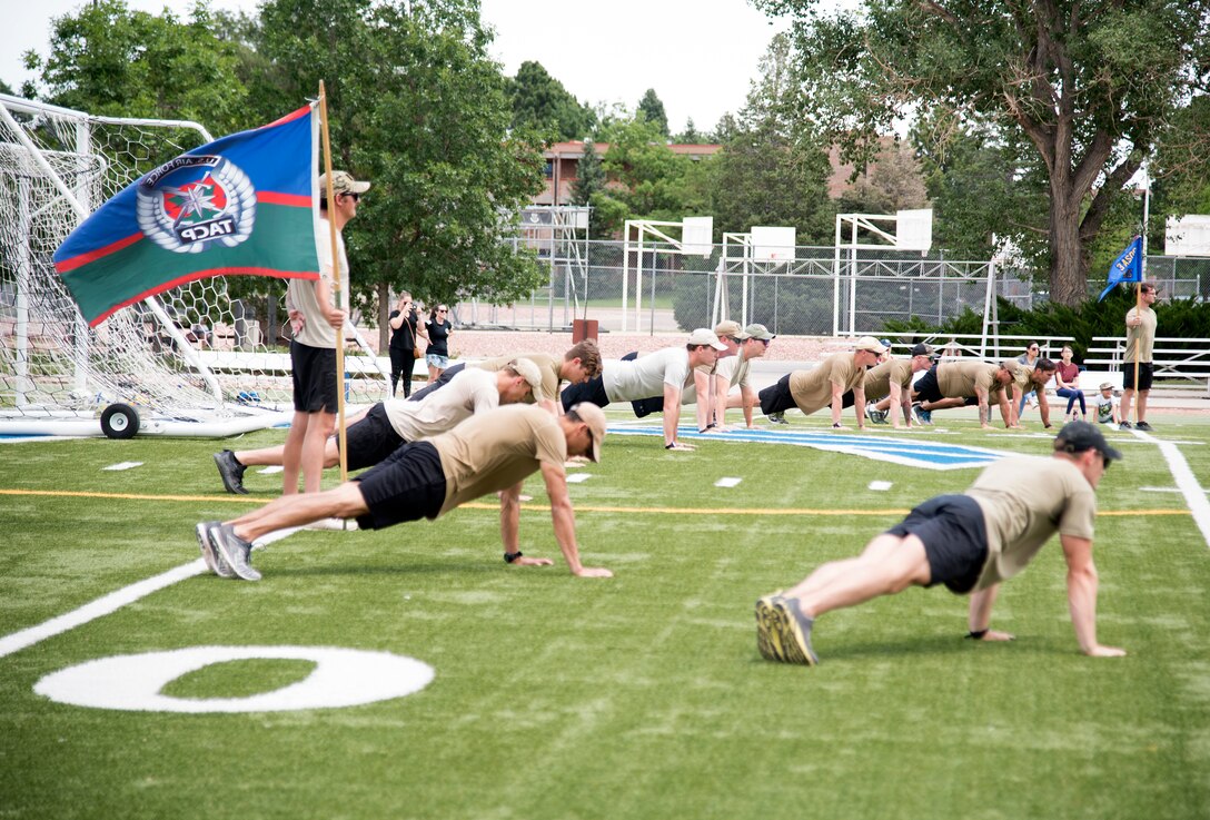 PETERSON AIR FORCE BASE, Colo. - Airmen from the 13th Air Support Operations Squadron complete push-ups in honor of 12 fallen service members after completing the ninth annual Tactical Air Control Party (TACP) Association 24-hour challenge run at the Peterson Air Force Base, Colorado, Fitness Center track July 13-14, 2020. The 24-hour challenge serves as a way to remember the fallen and bring awareness and support to the TACP Association, which helps TACP service members and their families. (U.S. Air Force photo by Kristen Allen)