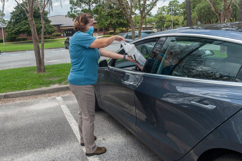 Photo of Airman delivering books