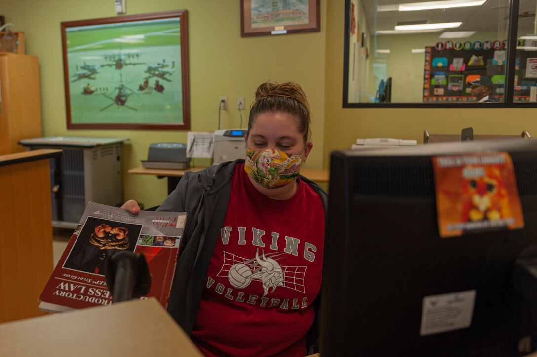 Photo of Airman scanning a book