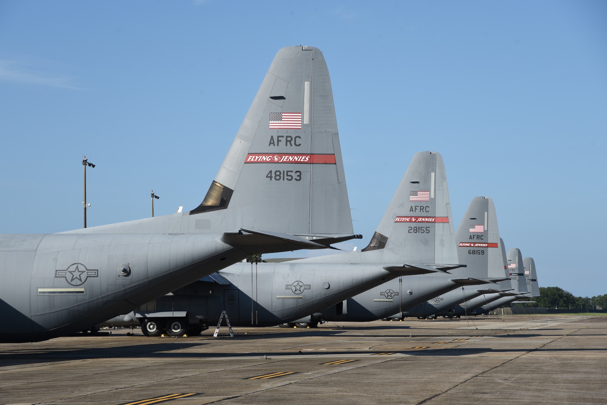A line of C-130J and W-C130J Super Hercules aircraft from the 815th Airlift and 53rd Weather Reconnaissance Squadrons on the flight line, July 17, 2020, Keesler Air Force Base, Mississippi. The mission of the 815th AS is to recruit, organize and train to deploy, redeploy and employ air and ground forces to any area of the world and provide them with logistical support. The 53rd WRS is tasked to collect weather data from within tropical storms and is the only Department of Defense unit that flies that mission. (U.S. Air Force photo by Tech. Sgt. Michael Farrar)