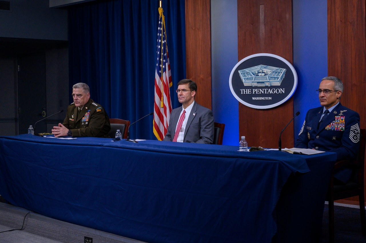 Defense Secretary Dr. Mark T. Esper; Army Gen. Mark A. Milley, chairman of the Joint Chiefs of Staff; and Senior Enlisted Advisor to the Chairman Ramón “CZ” Colón-López sit at a table.