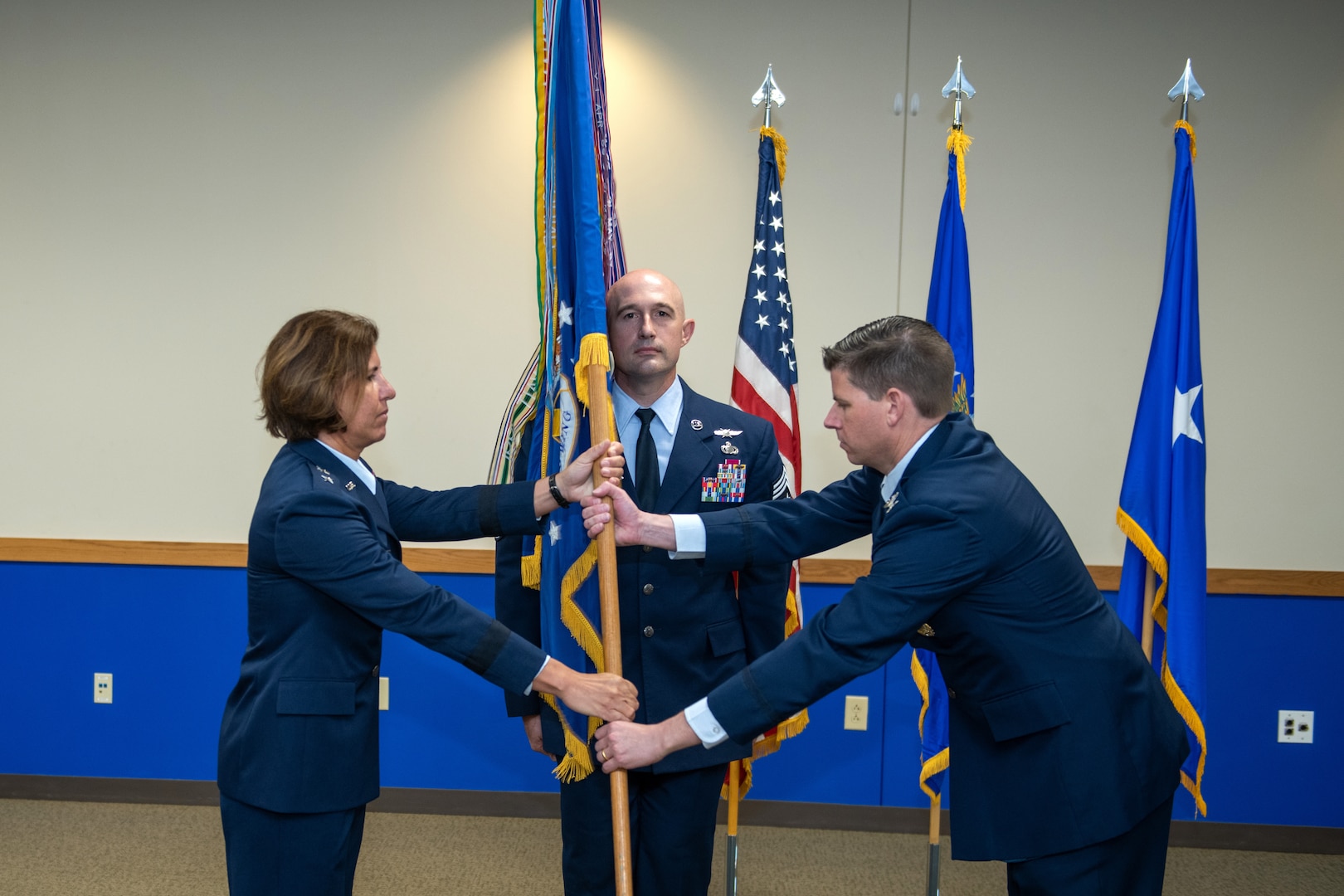 U.S. Air Force Maj. Gen. Andrea Tullos (left), Second Air Force commander, Keesler Air Force Base, Miss., passes the guidon to Col. Rockie Wilson (right), 37th Training Wing commander, during the change of command ceremony July 15, 2020