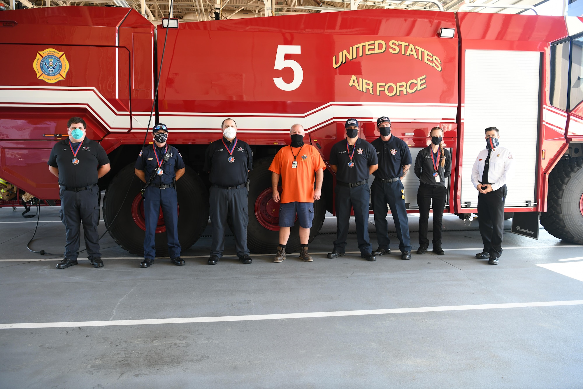 Photo of group standing in front of fire truck.