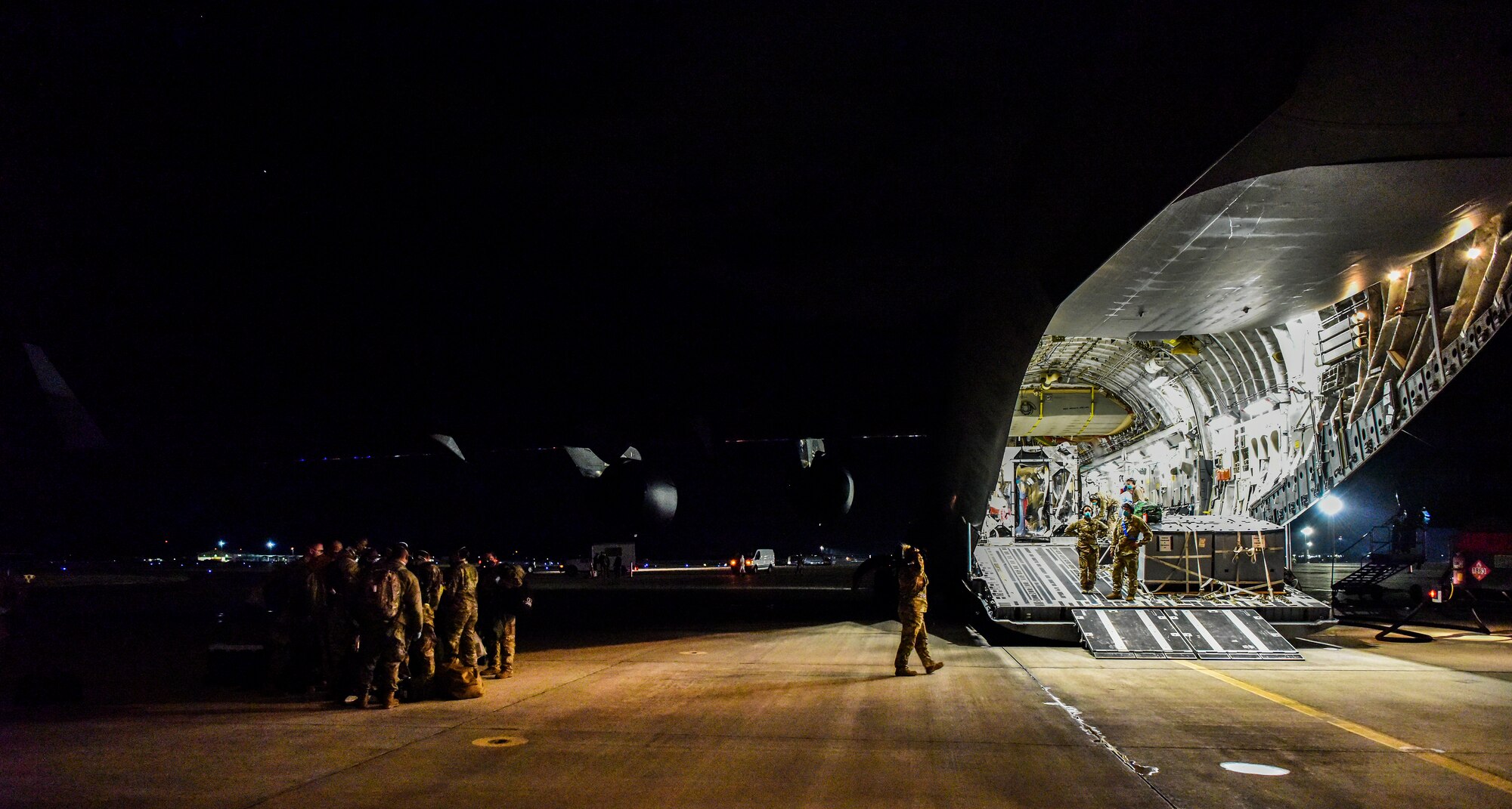 Airmen from the 60th Air Mobility Wing support a Transport Isolation System operation at Joint Base Pearl-Harbor Hickam, Hawaii, July 17, 2020. Several U.S. Air Force units came together to rapidly deploy the bio-containment capability for the first time in the Indo-Pacific theater in support of a COVID-19 aeromedical evacuation mission. The TIS is an infectious disease containment unit designed to minimize contamination risk to aircrew and medical attendants, while allowing in-flight medical care for patients afflicted by a disease. (U.S. Air Force photo by Tech. Sgt. Anthony Nelson Jr.)