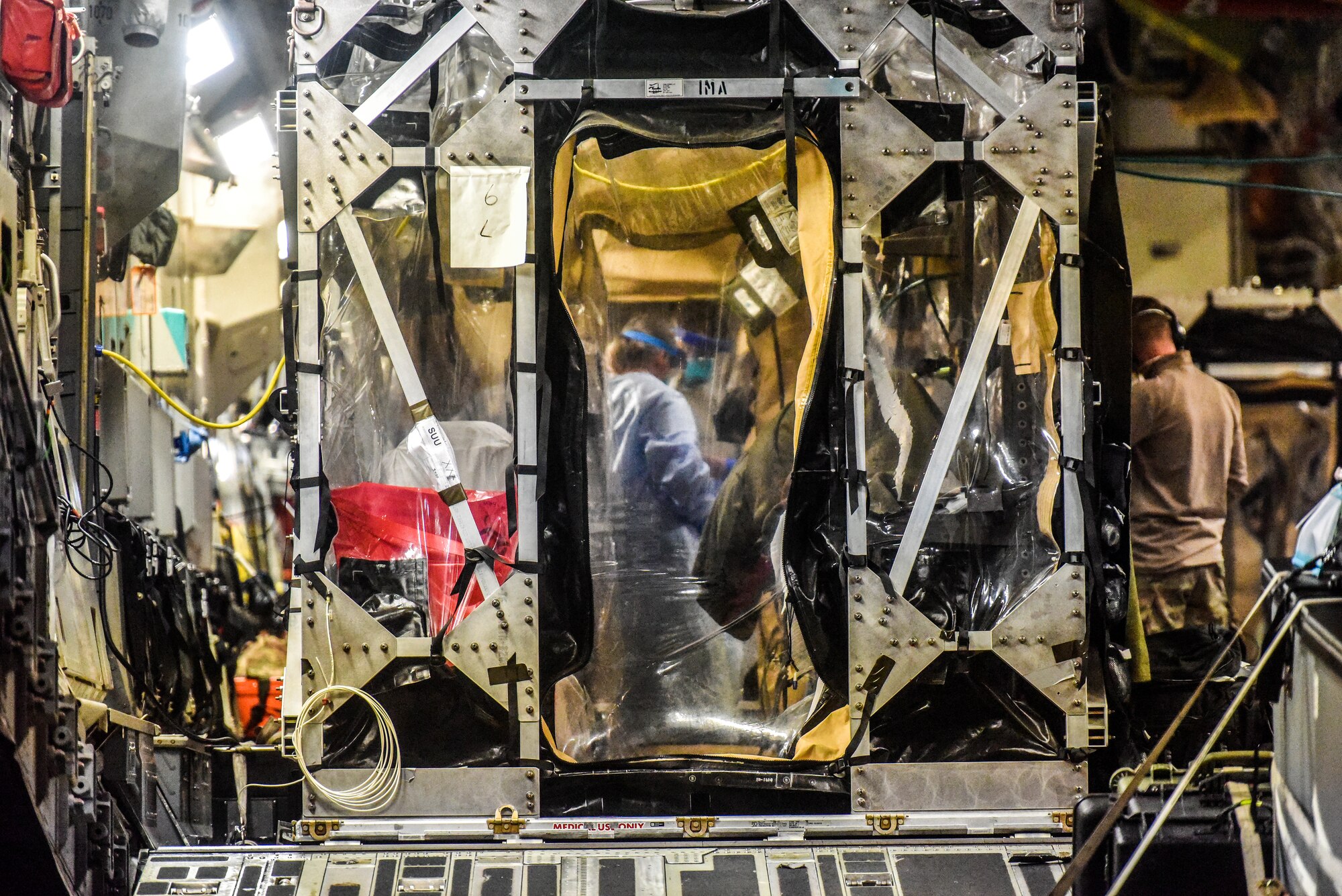 A 60th Air Mobility Wing C-17 from Travis Air Force Base, California, support a Transport Isolation System operation at Joint Base Pearl-Harbor Hickam, Hawaii, July 17, 2020. A team of Airmen from several commands rapidly executed a Transport Isolation System in support of a COVID-19 bio-containment aeromedical evacuation mission. This is the first time the TIS was utilized in the Indo-Pacific area of operations. The TIS is an infectious disease containment unit designed to minimize contamination risk to aircrew and medical attendants, while allowing in-flight medical care for patients afflicted by a disease. (U.S. Air Force photo by Tech. Sgt. Anthony Nelson Jr.)