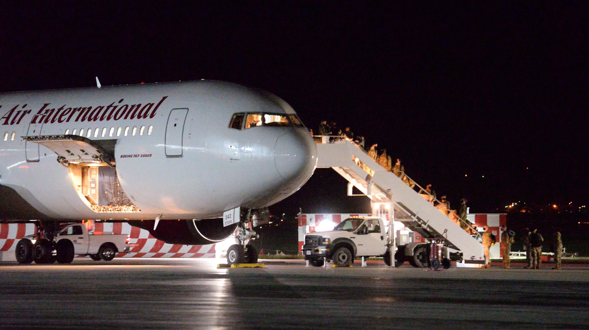 Airmen from the 28th Bomb Wing board a Boeing 767 at Ellsworth Air Force Base, S.D., for a Bomber Task Force deployment to the U.S. Indo-Pacific Command area of responsibility July 14, 2020. During the deployment, approximately 170 Airmen and four B-1B Lancers assigned to the 37th Bomb Squadron will conduct missions in the USINDOPACOM arena aimed at maintaining global stability and security in the region. (U.S. Air Force photo by Airman Quentin K. Marx)
