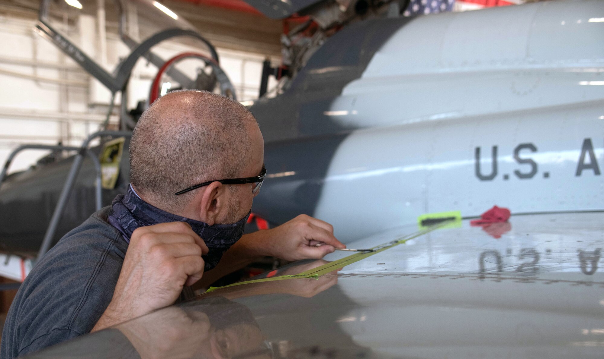 Scott Matthews, 12th Maintenance Squadron crew member, seals a T-38C wing to prevent corrosion at Joint Base San Antonio-Randolph July 14.