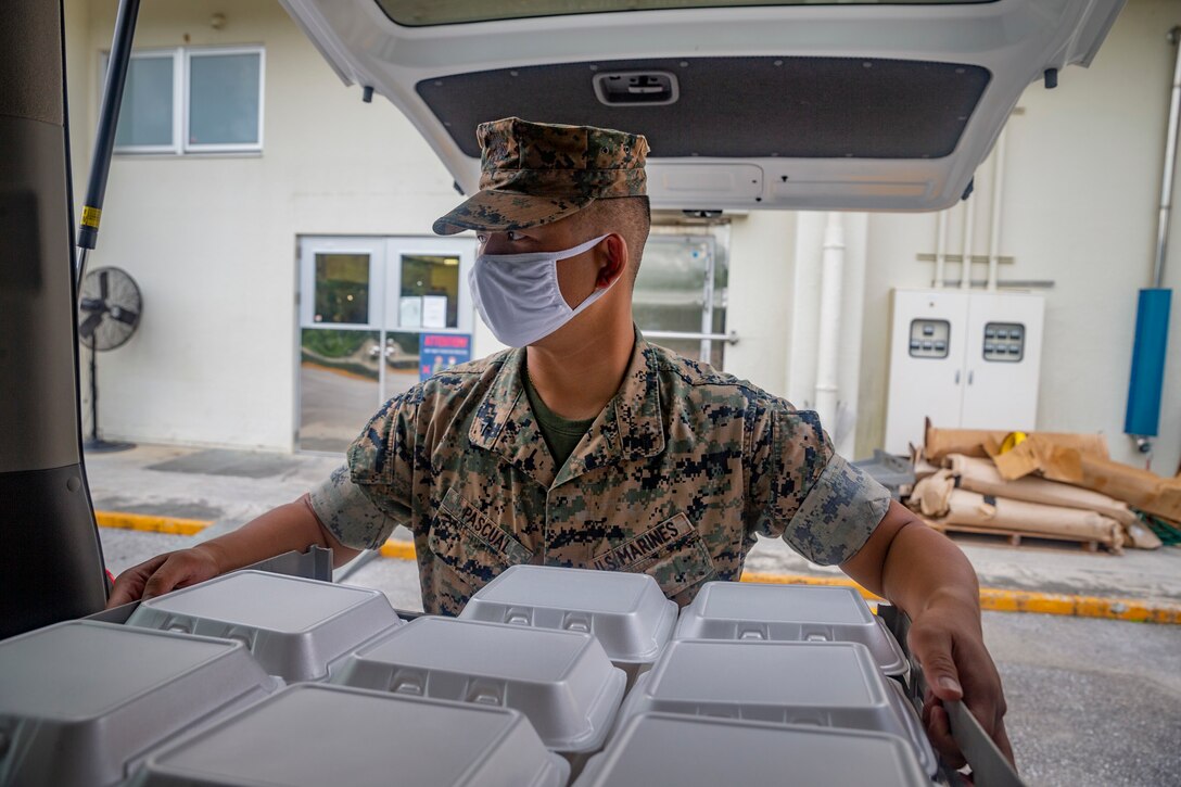 U.S. Marines Corps Lance Cpl. Jonathan Paschal, a driver within the Joint Reception Center (JRC) brings chow to the Marines on restriction of movement (ROM) on Camp Foster, July 9, 2020. The JRC staff drives to Kadena Air Base to transport the Marines and greenside sailors to the barracks to execute a 14-day ROM, followed by a week of welcome aboard classes to orient them to the new island. (U.S. Marine Corps photo by Lance Cpl. Karis Mattingly)