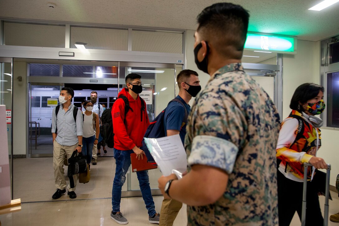 U.S. Marines Corps Lance Cpl. Jonathan Paschal, a driver within the Joint Reception Center (JRC) welcomes the new Marines to the island of Okinawa on Kadena Air Base, July 9, 2020. The JRC staff drive to Kadena Air Base to transport the Marines and greenside sailors to the barracks to execute a 14-day restriction of movement (ROM), followed by a week of welcome aboard classes to orient them to the new island. (U.S. Marine Corps photo by Lance Cpl. Karis Mattingly)