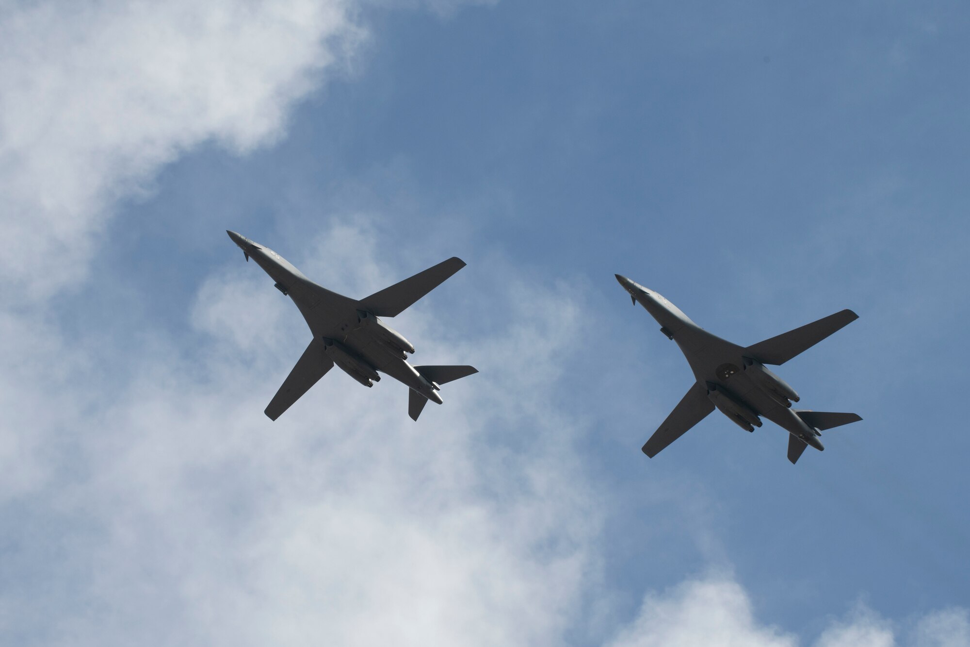 Two B-1B Lancers, assigned to the 28th Bomb Wing, Ellsworth Air Force Base, S.D., conduct a flyover before landing at Andersen AFB, Guam, July 17, 2020. The Bomber Task Force is deployed to Andersen AFB in support of Pacific Air Forces’ training efforts with allies, partners and joint forces. (U.S. Air Force Photo by Airman 1st Class Christina Bennett)