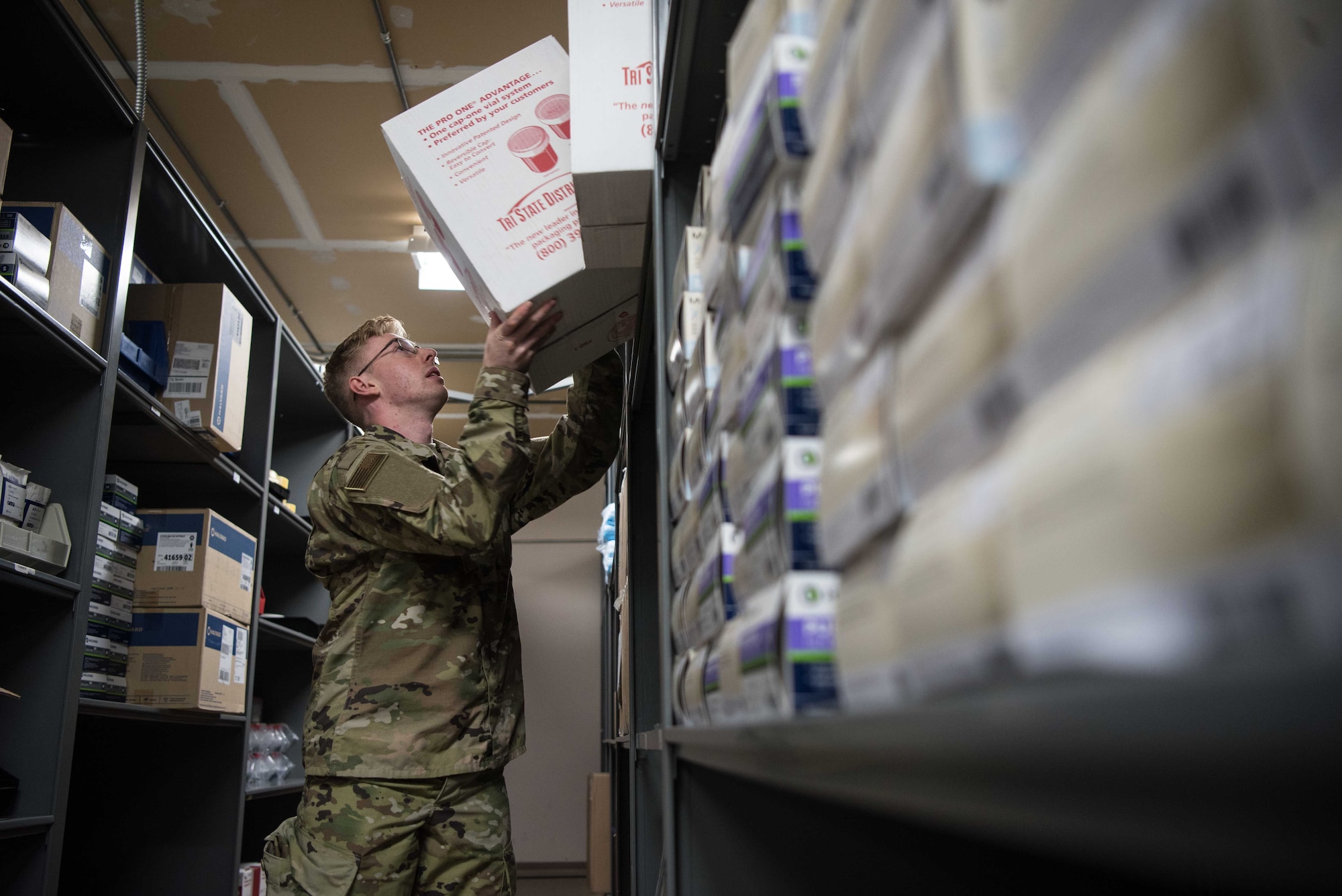U.S. Air Force Airman 1st Class Bailey Pitcher, 22nd Medical Support Squadron acquisitions technician, prepares equipment at McConnell Air Force Base, Kansas, July 15, 2020. Medical material Airmen can receive an average of four to five shipments a day. Once the medical material team receives packages, they are opened, logged and delivered to the requesting clinic. (U.S. Air Force photo by Senior Airman Alexi Bosarge)