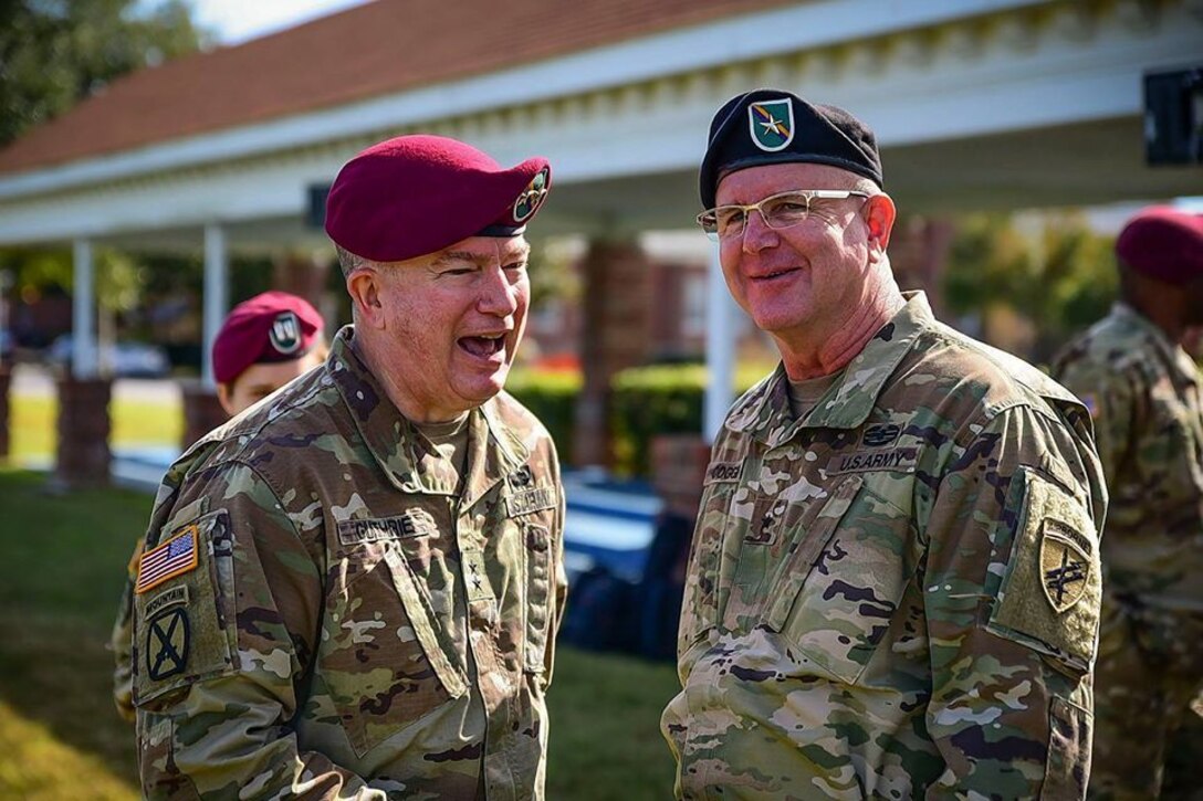 U.S. Army Civil Affairs & Psychological Operations Command (Airborne) commander, MG Darrell J. Guthrie (left), and Brig. Gen. Jeffrey Coggin (right) share a moment together as they celebrate following the change-of-command ceremony held virtually 06 July 20. (U.S. Army reserve photo by Sgt. Dustin Gautney)