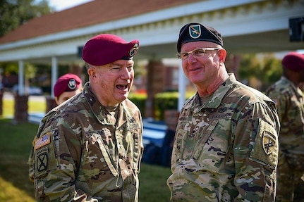 U.S. Army Civil Affairs & Psychological Operations Command (Airborne) commander, MG Darrell J. Guthrie (left), and Brig. Gen. Jeffrey Coggin (right) share a moment together as they celebrate following the change-of-command ceremony held virtually 06 July 20. (U.S. Army reserve photo by Sgt. Dustin Gautney)