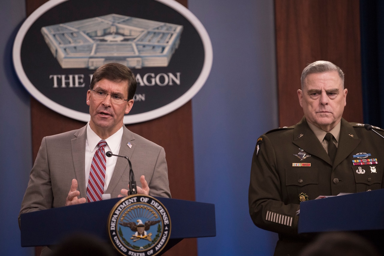 Two men, one in an Army uniform, stand at lecterns in the Pentagon.