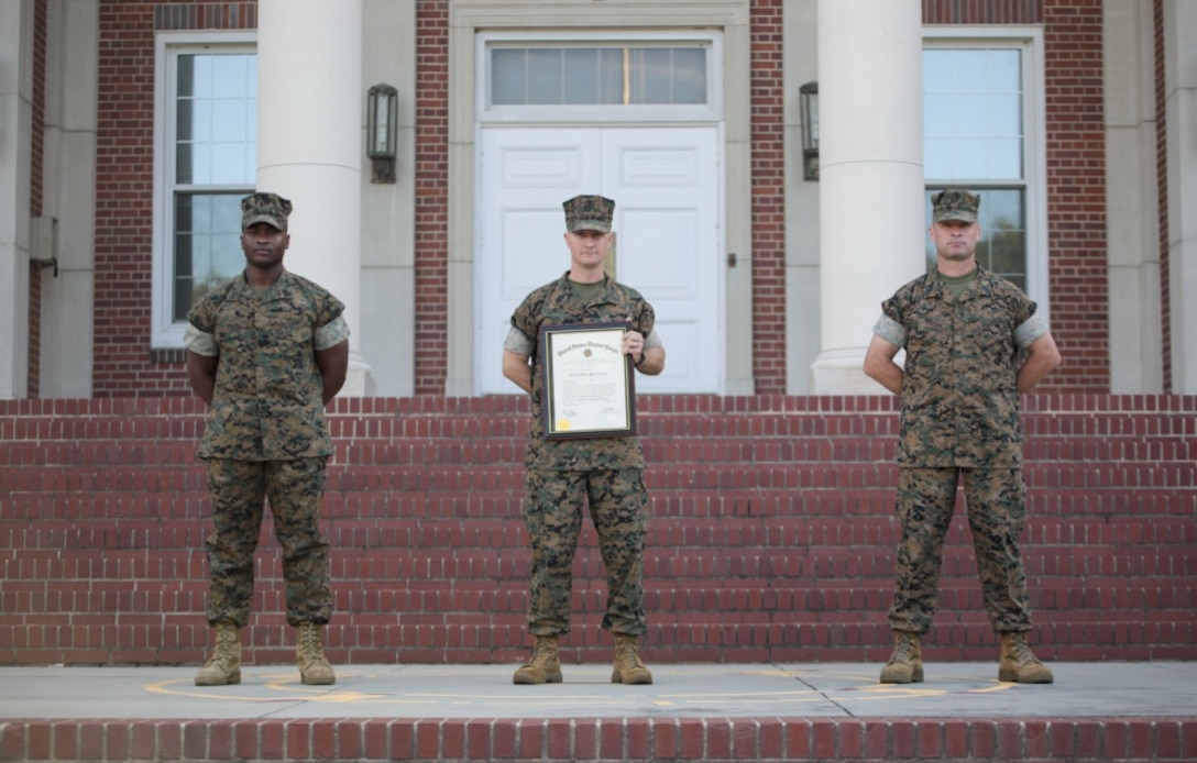 Master Sgt. Justin Gregory stands with his recruiter Master Gunnery Sgt. Dinky Byers and senior drill instructor Master Gunnery Sgt. Doug Mrusek after Gregory’s promotion on Marine Corps Recruit Depot Parris Island S.C. July 1, 2020.