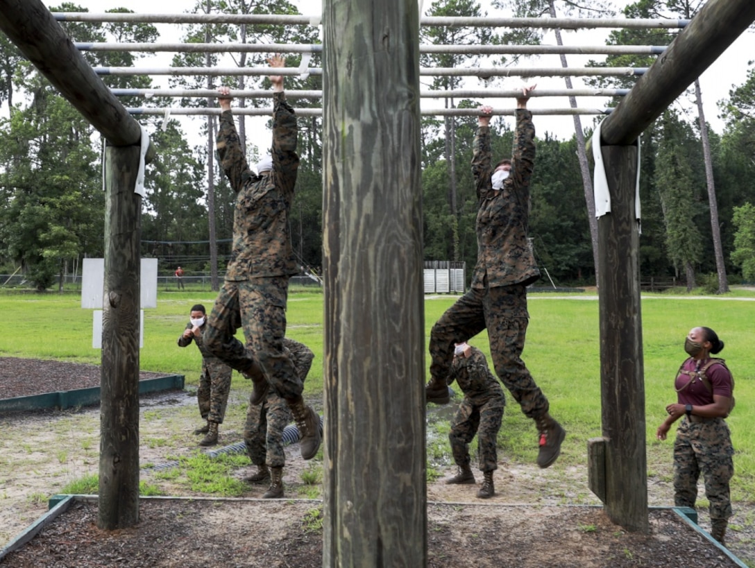 Recruits with Oscar Company, 4th Recruit Training Battalion, navigate an obstacle during the confidence course aboard Marine Corps Recruit Depot Parris Island, S.C., June 22, 2020. The Confidence Course is composed of various obstacles that both physically and mentally challenge recruits.