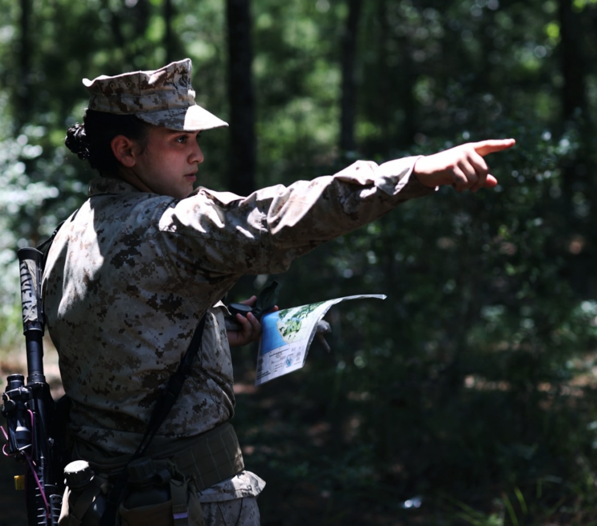 Recruit Raquel Rivera with Papa Company, 4th Recruit Training Battalion, gives directions during the land navigation course aboard Marine Corps Recruit Depot Parris Island, S.C, June 14, 2020. Land navigation is part of Basic Warrior Training and is designed to teach recruits how to use a compass and map for navigation.