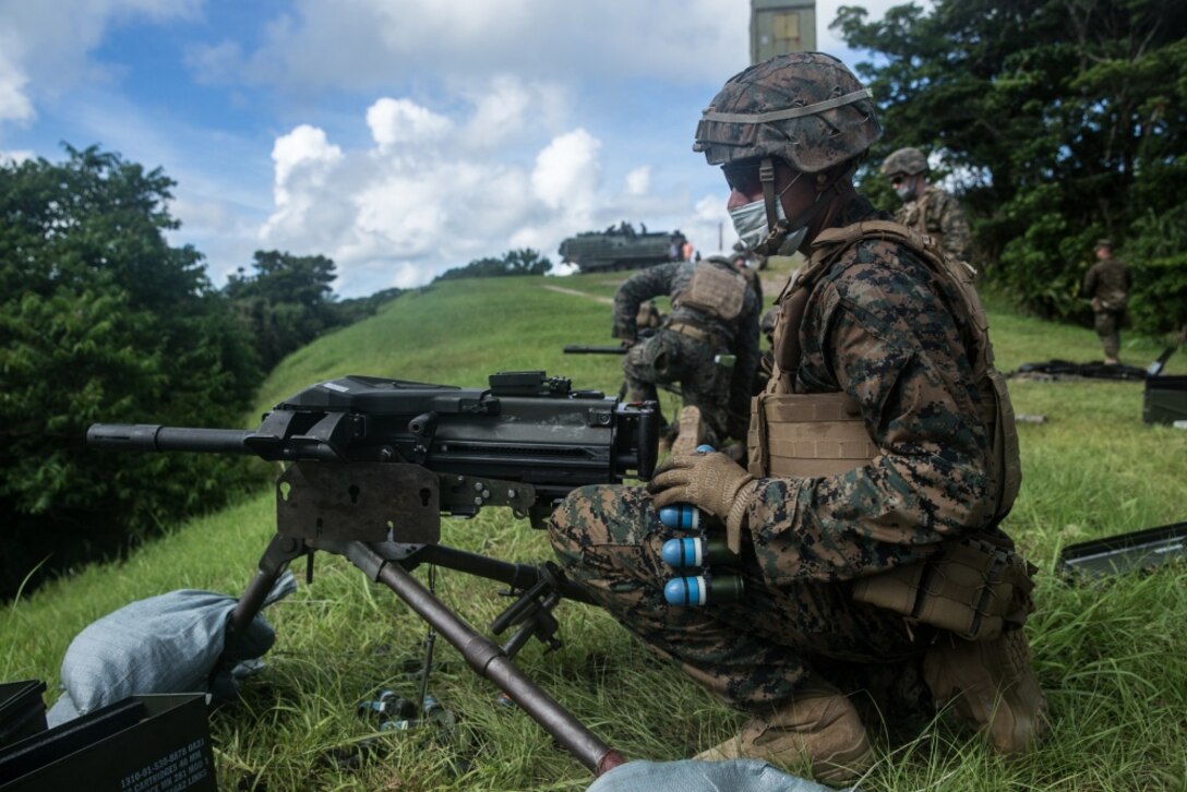 A Marine with Battalion Landing Team, 2nd Battalion, 4th Marines, 31st Marine Expeditionary Unit (MEU) prepares to load 40mm practice M781 rounds into an Mk-19 at Camp Schwab, Okinawa, Japan, June 29, 2020. The 31st MEU, the Marine Corps’ only continuously forward-deployed MEU, provides a flexible and lethal force ready to perform a wide range of military operations as the premier crisis response force in the Indo-Pacific region. The 31st MEU has implemented strict health protection measures and will continue to conduct mission essential training in support of regional security and stability. (U.S. Marine Corps photo by Lance Cpl. Kolby Leger)