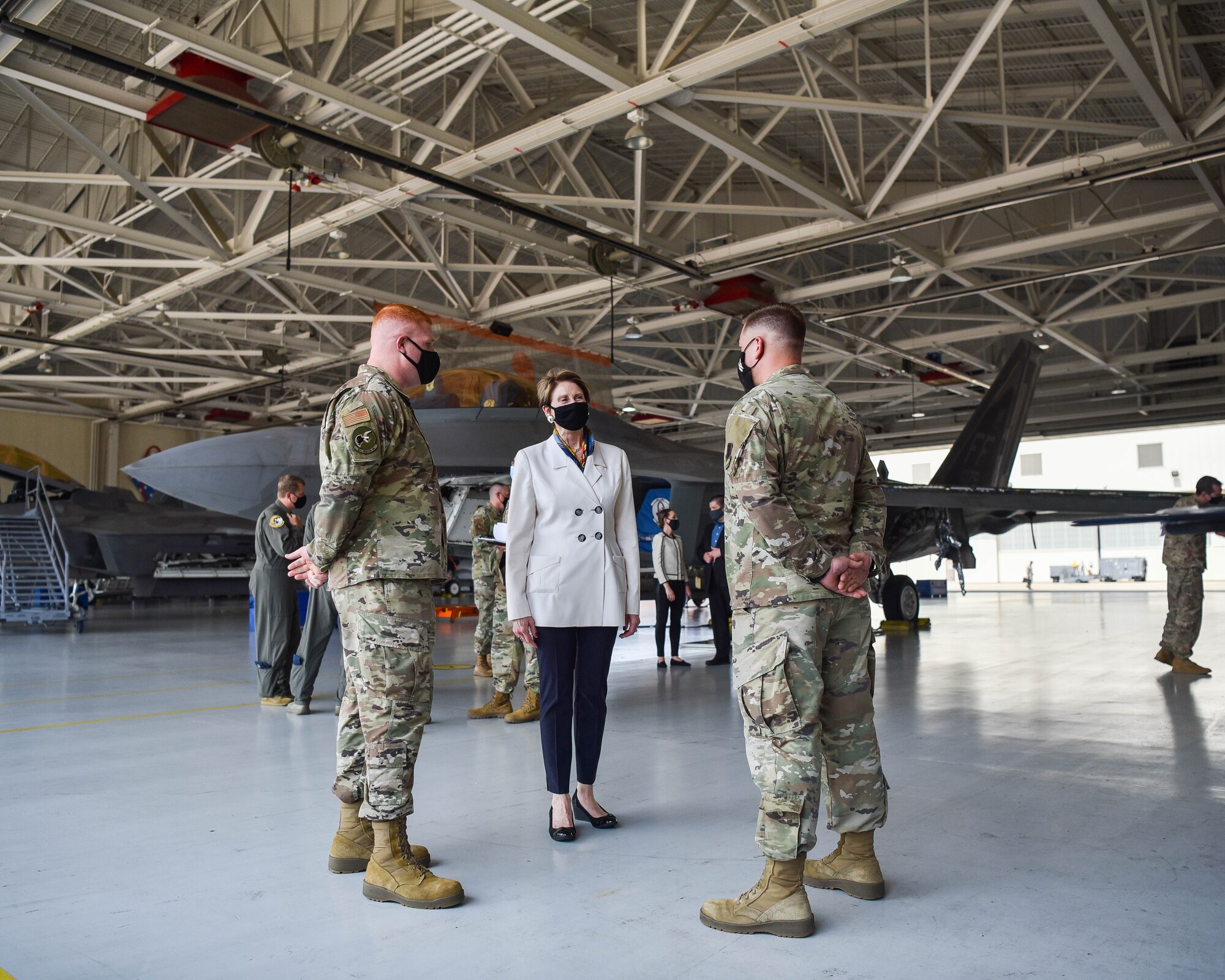 Secretary of the Air Force Barbara M. Barrett speaks with Airmen in front of a U.S. Air Force F-22 Raptor at the 94th Aircraft Maintenance Unit at Joint Base Langley-Eustis, Virginia, July 17, 2020. Barrett received briefings about how Airmen are keeping the F-22s maintained and mission ready in the midst of the Coronavirus pandemic. (U.S. Air Force photo by Senior Airman Marcus M. Bullock)